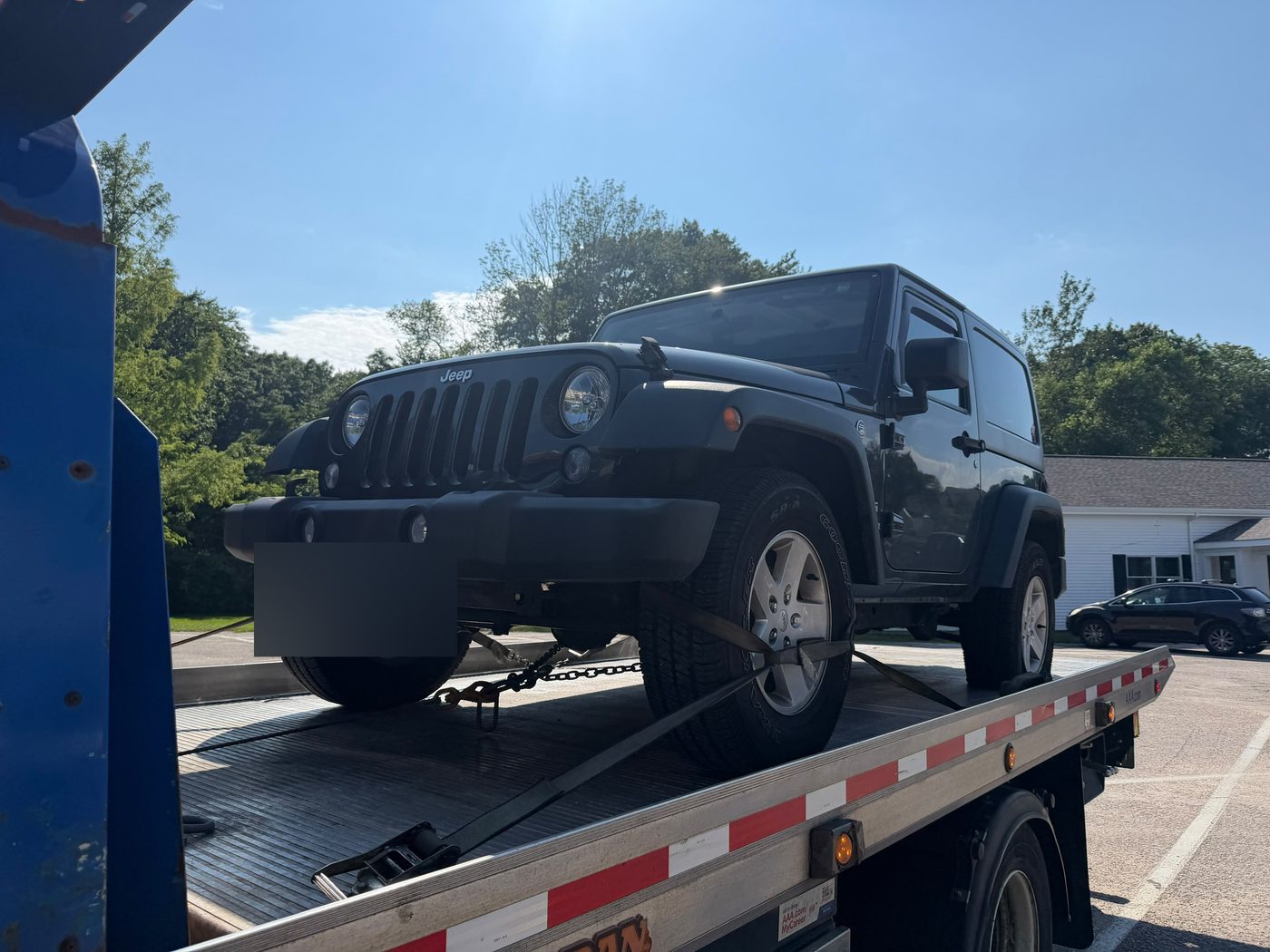 Jeep Wrangler loaded on a Centri Auto flatbed tow truck