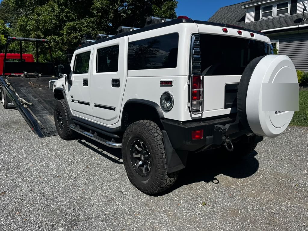 Hummer H2 loaded onto a Centri Auto flatbed tow truck