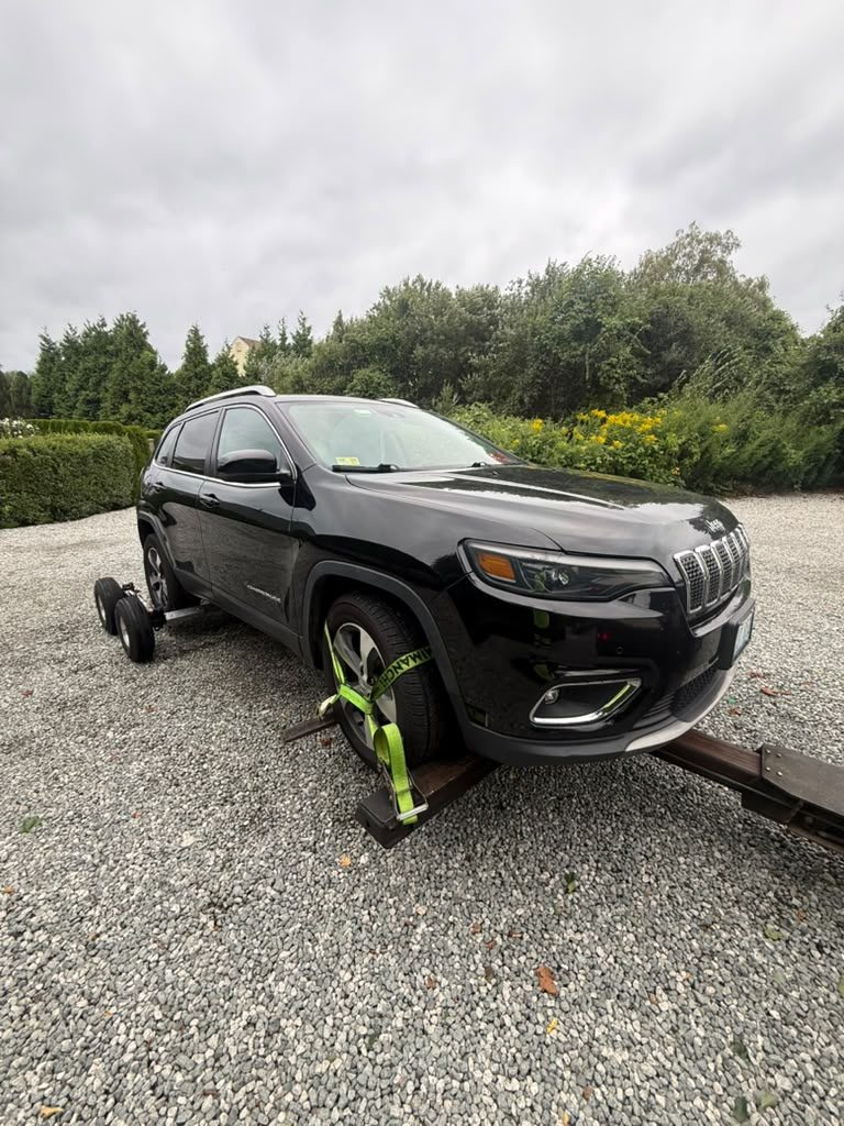 Jeep Cherokee on a tow dolly, front view