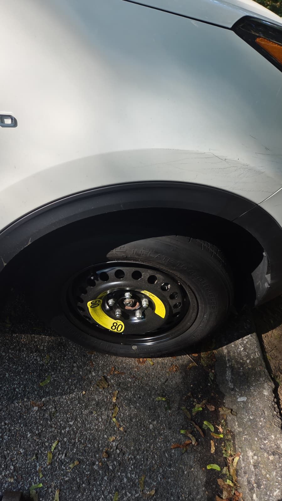 Spare tire fitted on a vehicle during roadside service