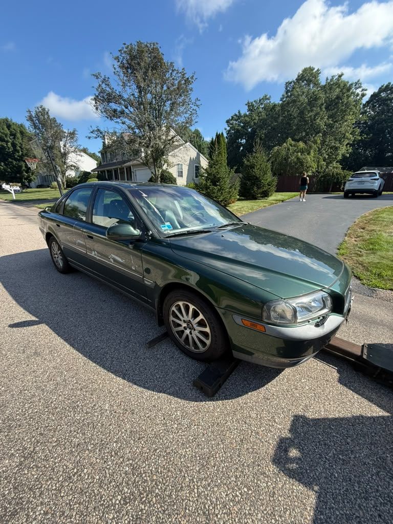 Sedan loaded onto a Centri Auto flatbed tow truck in a residential driveway