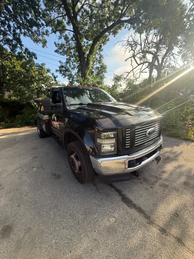 Dark Ford tow truck at the yard in the evening light