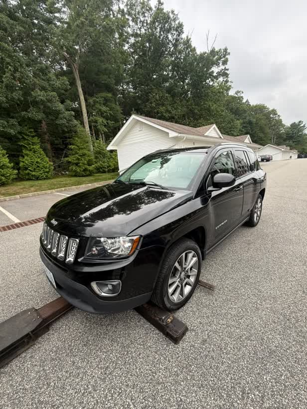 Black Jeep Compass loaded on the flatbed