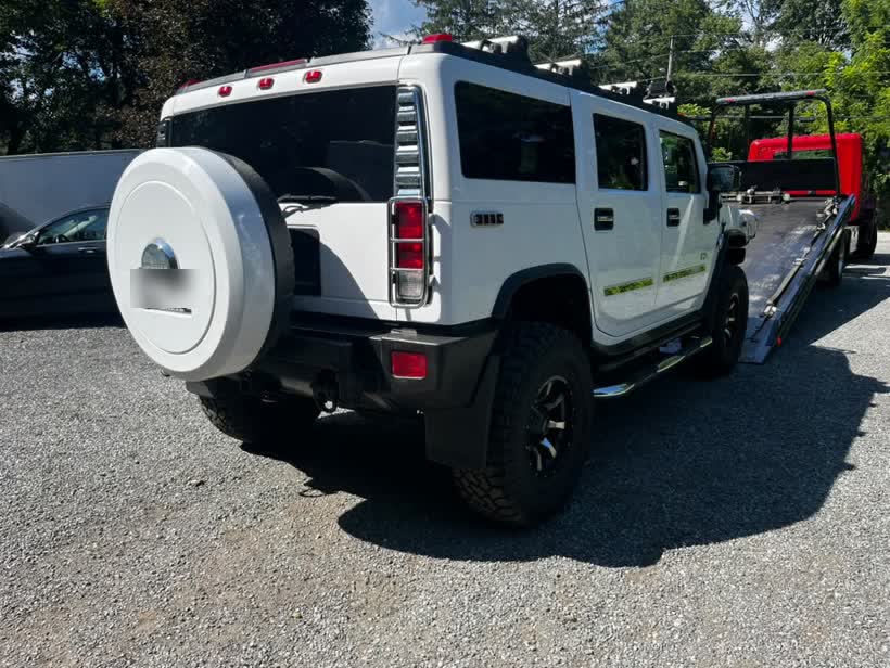 White Hummer loaded, rear view